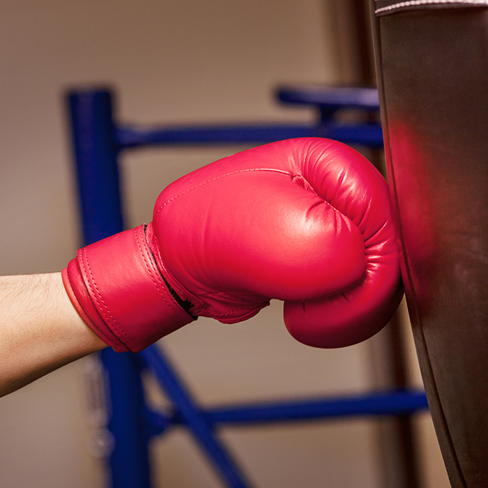 close up hand boxer moment impact punching bag